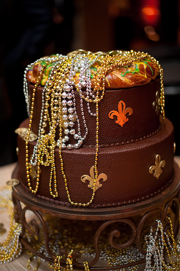 brown and gold wedding cake covered with beaded neclaces -photo by Houston based wedding photographer Adam Nyholt